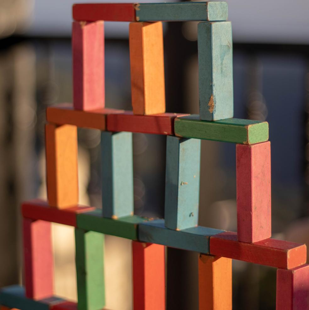 3 stacks of multi coloured building blocks