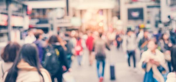 Photo of people walking down a street, blurred with movement