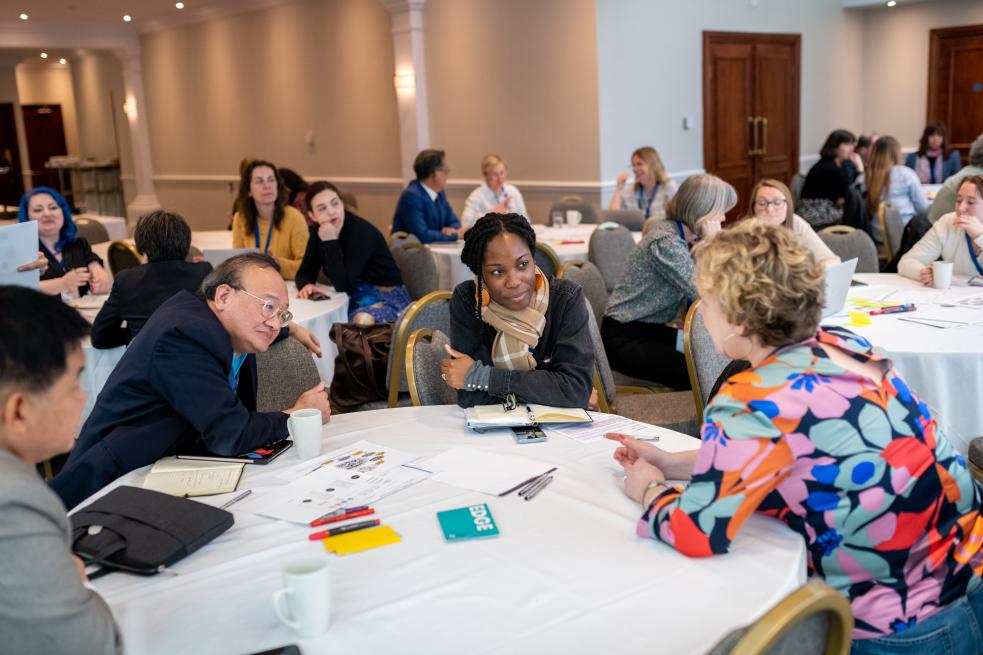 A group of people sitting around a table in discussion at Engage 2024