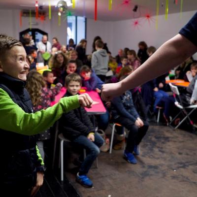 Young person fist-bumping adult