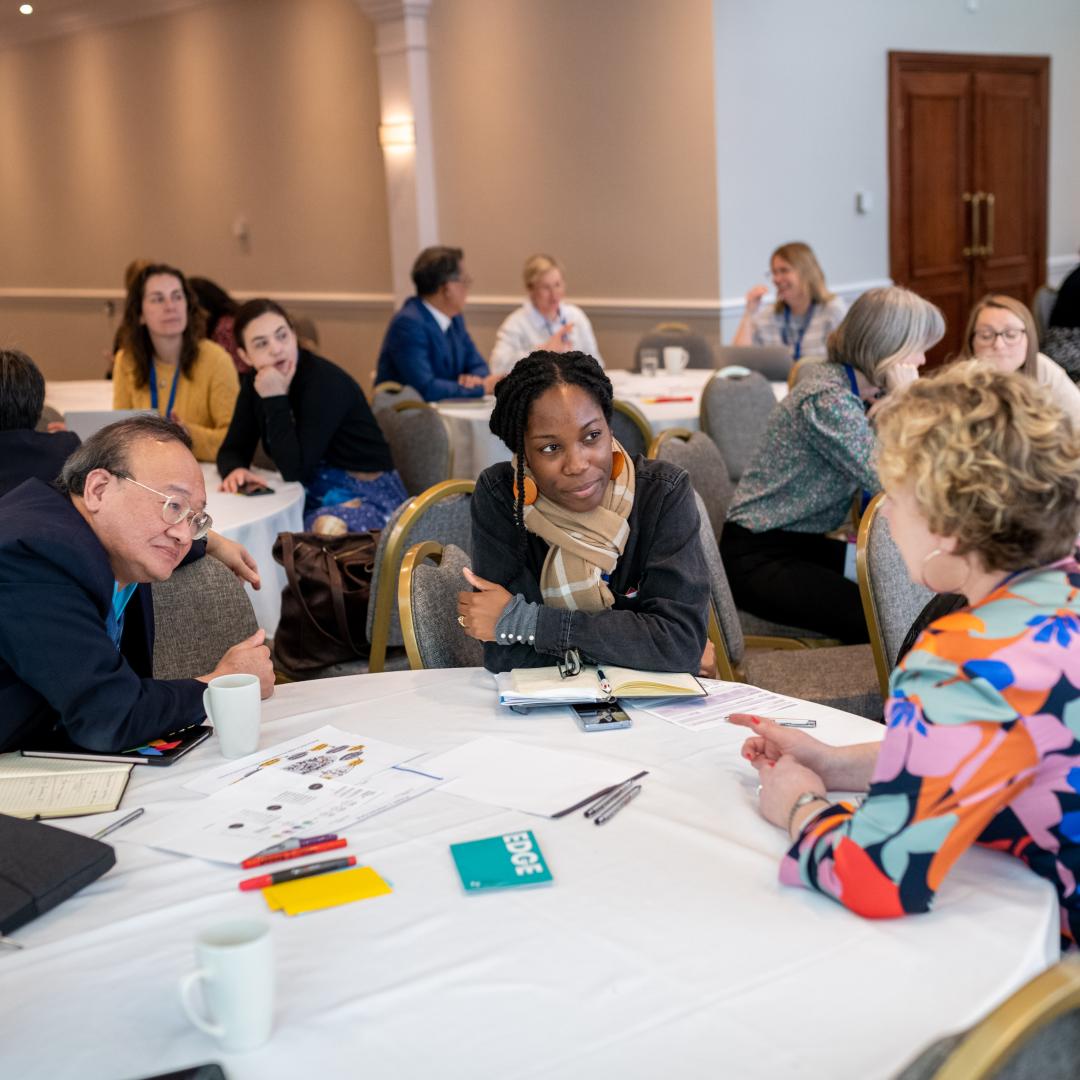 A group of people sitting around a table in discussion at Engage 2024